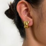 sway stud earrings wearing by an woman