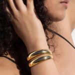 golden arc cuff wear by an woman