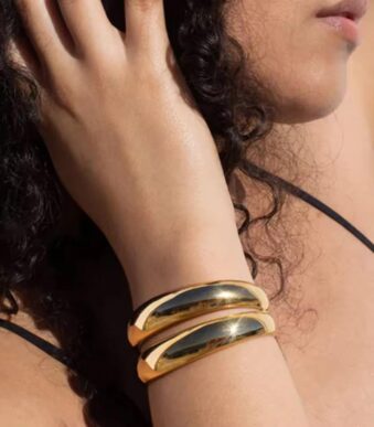 golden arc cuff wear by an woman