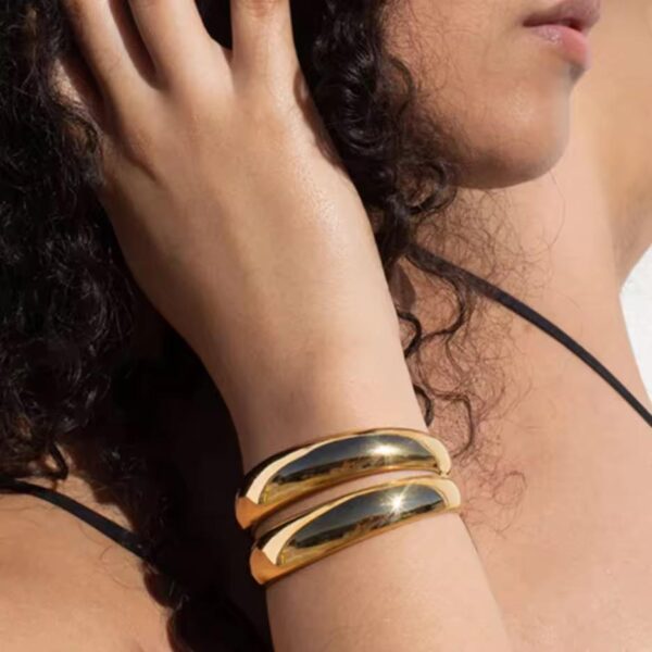 golden arc cuff wear by an woman