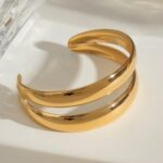 golden arc cuff placed on a table